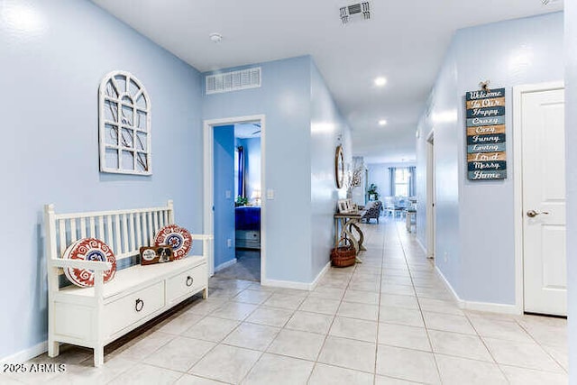 hall with light tile patterned floors