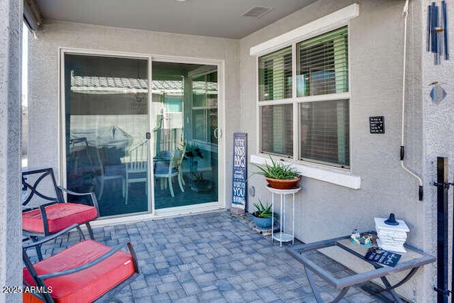 doorway to property with a patio