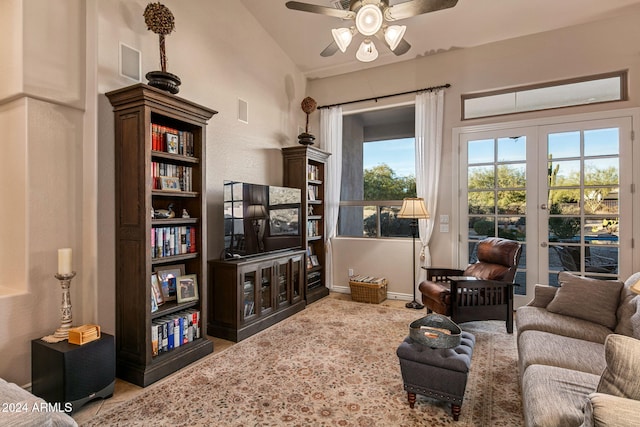 living room with ceiling fan, vaulted ceiling, and french doors