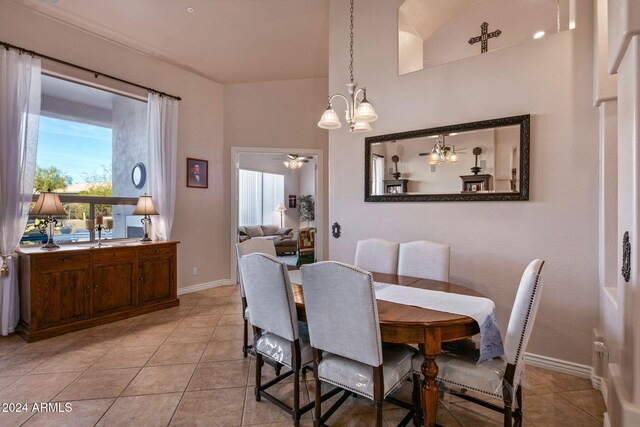 tiled dining room featuring a notable chandelier