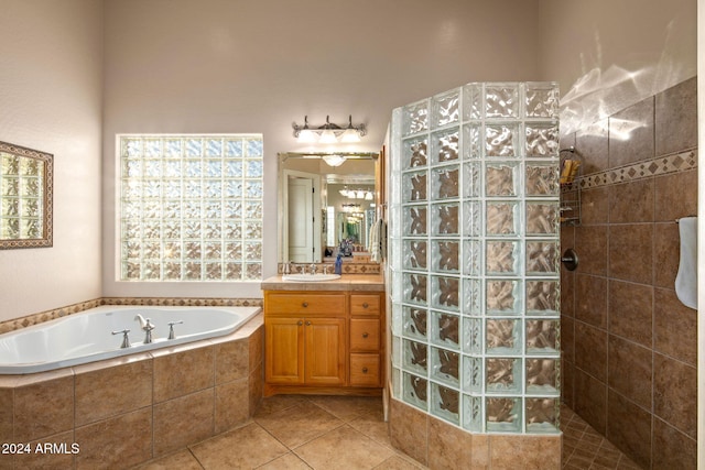 bathroom with tile patterned floors, vanity, and separate shower and tub