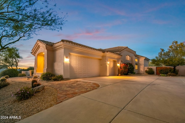 mediterranean / spanish-style house featuring a garage