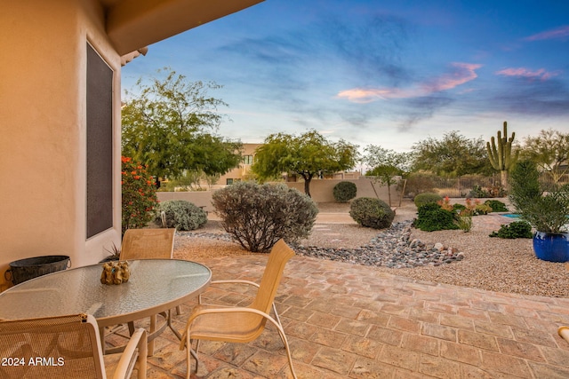 view of patio terrace at dusk