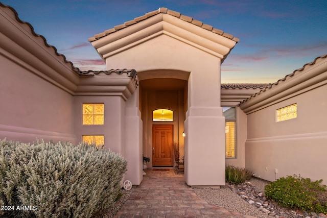 view of exterior entry at dusk