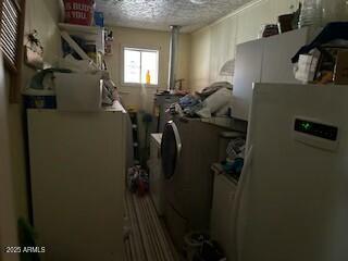 interior space featuring washer / clothes dryer and a textured ceiling