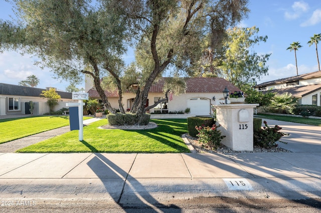 view of front of property featuring a tiled roof, a front yard, and stucco siding