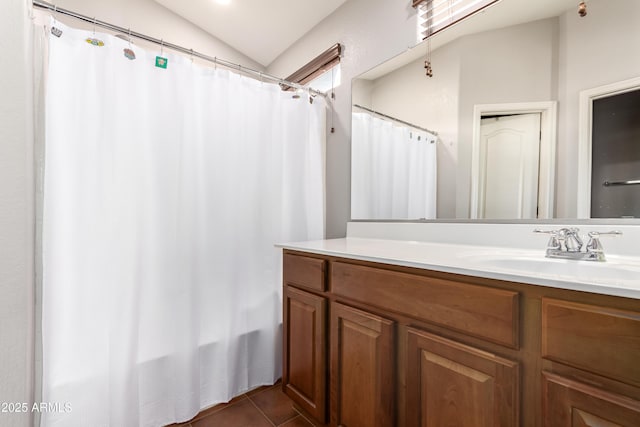 bathroom featuring tile patterned flooring, curtained shower, lofted ceiling, and vanity