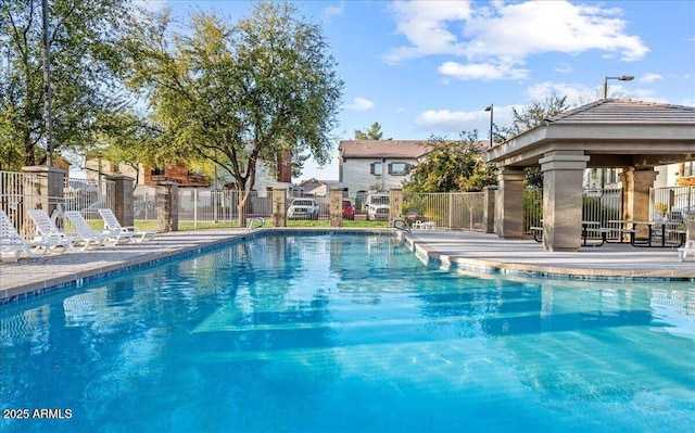 pool featuring a gazebo and fence
