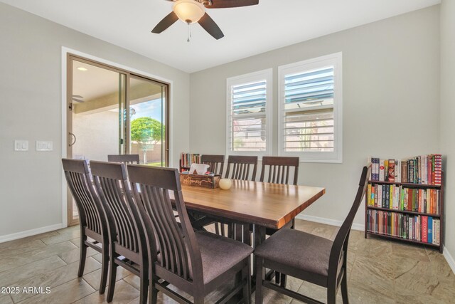 dining area featuring baseboards, a wealth of natural light, and ceiling fan