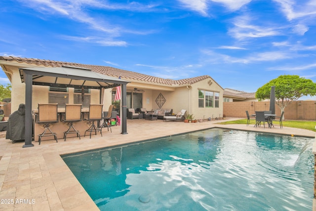 view of pool featuring an outdoor living space, a patio area, fence, and outdoor dry bar