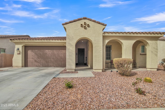 mediterranean / spanish house featuring covered porch, stucco siding, an attached garage, and driveway