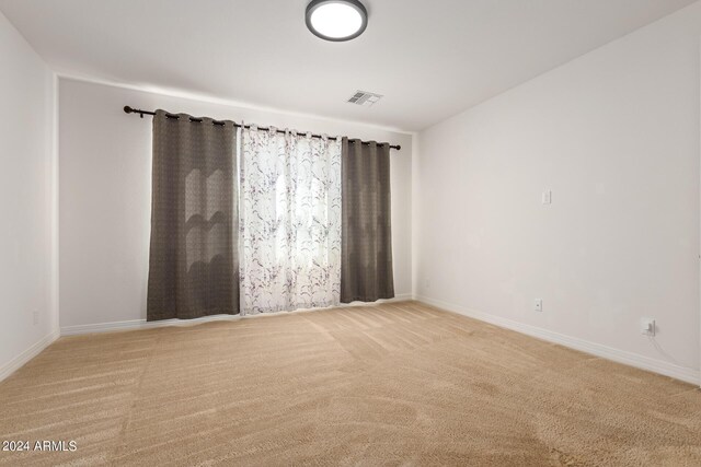 empty room featuring light colored carpet