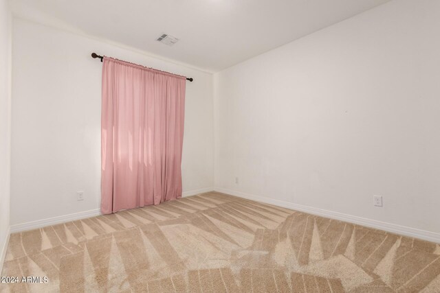 unfurnished room with light carpet