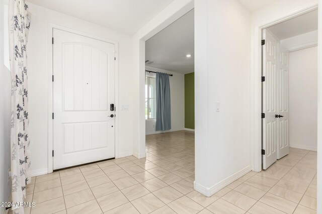 foyer entrance featuring light tile patterned flooring