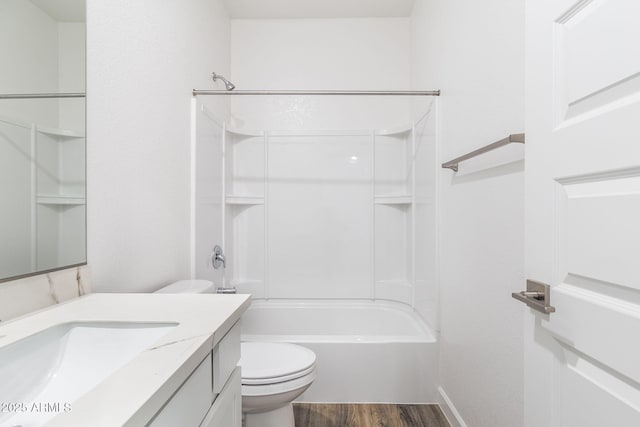 full bathroom with hardwood / wood-style flooring, shower / washtub combination, vanity, and toilet