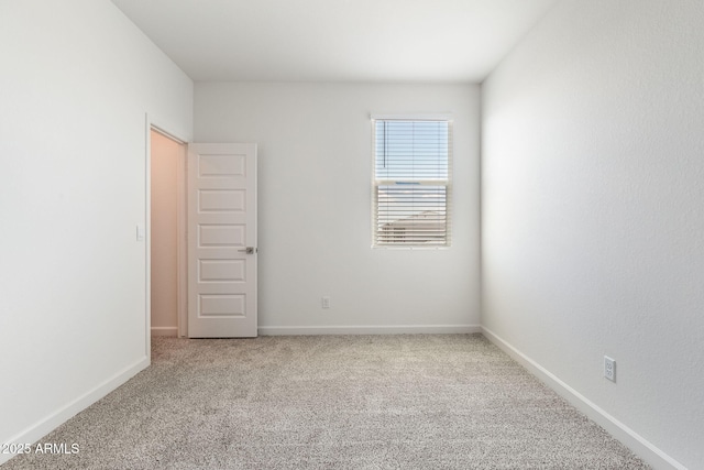 unfurnished room featuring light carpet