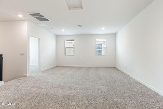 spare room featuring light colored carpet