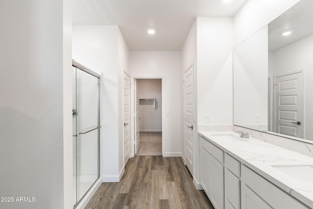 bathroom with vanity, hardwood / wood-style floors, and an enclosed shower