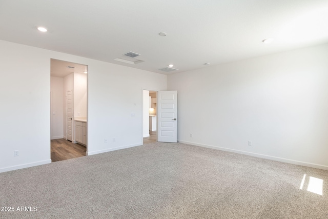 spare room featuring light colored carpet