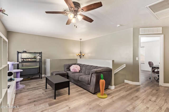 12517 W Santa Fe Ln, El Mirage, AZ 85335 - living area with baseboards, wood finished floors, visible vents, and ceiling fan with notable chandelier