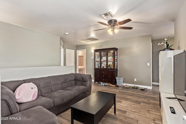 12517 W Santa Fe Ln, El Mirage, AZ 85335 - living room with baseboards, a ceiling fan, visible vents, and light wood-style floors