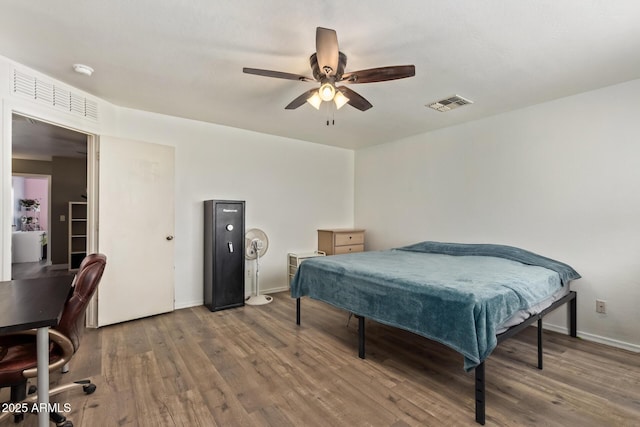 12517 W Santa Fe Ln, El Mirage, AZ 85335 - bedroom with baseboards, a ceiling fan, wood finished floors, and visible vents