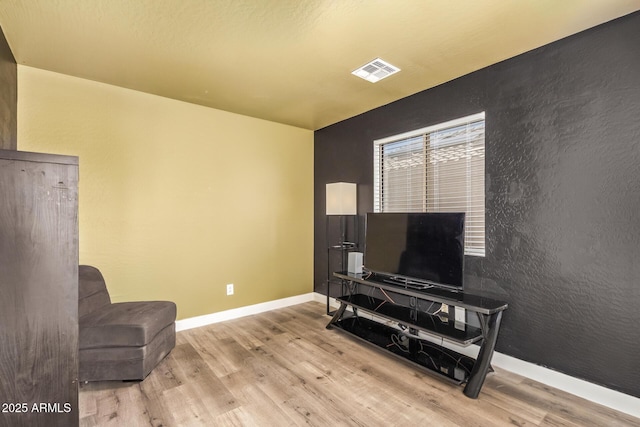 12517 W Santa Fe Ln, El Mirage, AZ 85335 - living area with baseboards, wood finished floors, and visible vents