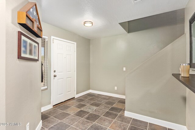 12517 W Santa Fe Ln, El Mirage, AZ 85335 - foyer with dark tile patterned flooring and baseboards