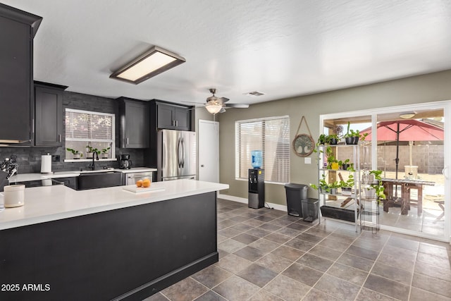 12517 W Santa Fe Ln, El Mirage, AZ 85335 - kitchen with light countertops, visible vents, stainless steel appliances, and a healthy amount of sunlight