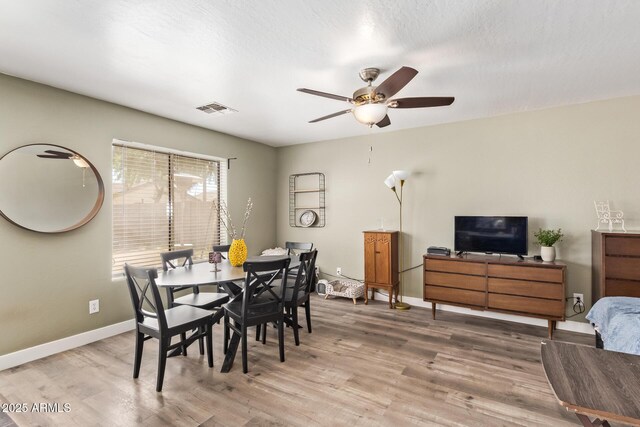 12517 W Santa Fe Ln, El Mirage, AZ 85335 - dining space featuring baseboards, light wood-style flooring, visible vents, and ceiling fan