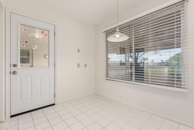 19402 N Welk Dr, Sun City, AZ 85373 - unfurnished dining area featuring light tile patterned floors and baseboards