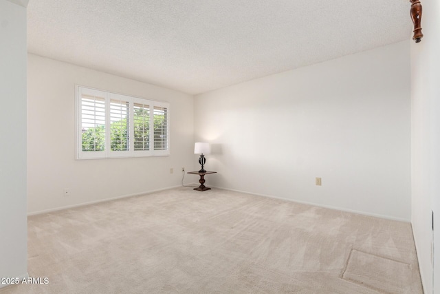 19402 N Welk Dr, Sun City, AZ 85373 - unfurnished room with a textured ceiling, baseboards, and carpet floors