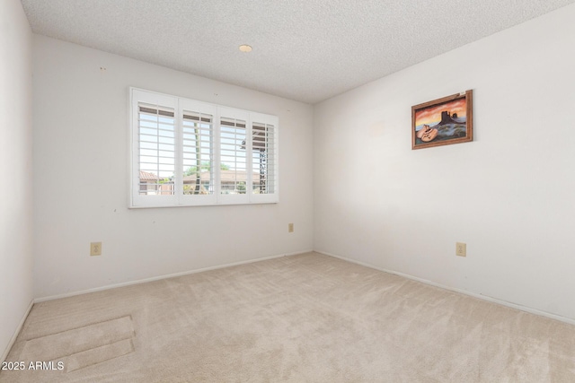 19402 N Welk Dr, Sun City, AZ 85373 - carpeted spare room featuring a textured ceiling and baseboards