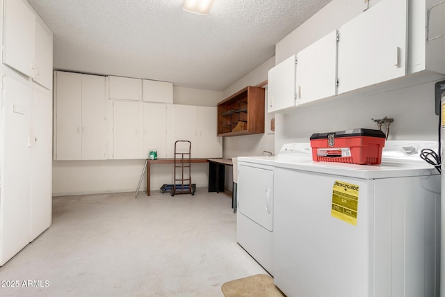 19402 N Welk Dr, Sun City, AZ 85373 - laundry room with washer and dryer, a textured ceiling, and cabinet space