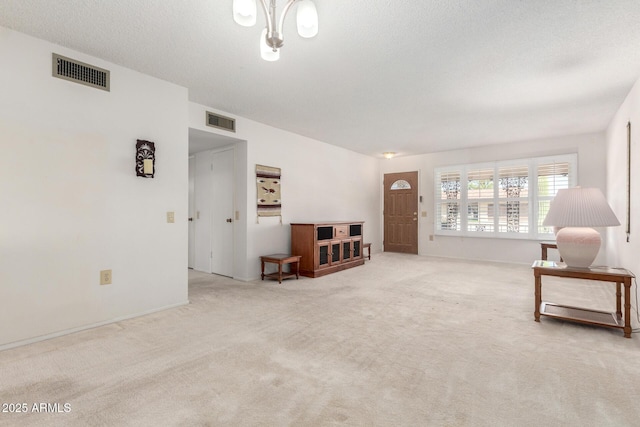 19402 N Welk Dr, Sun City, AZ 85373 - living area with visible vents, a textured ceiling, and carpet floors