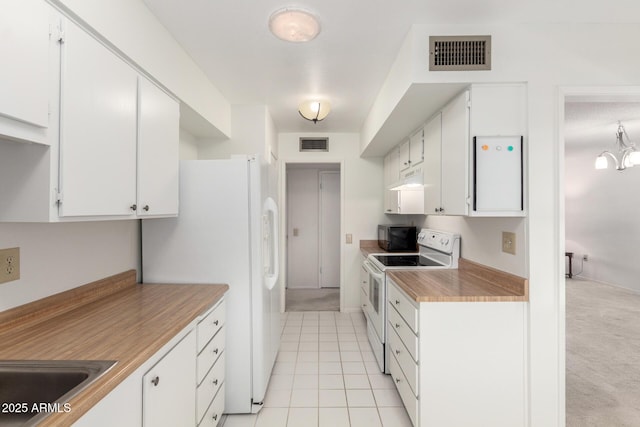 19402 N Welk Dr, Sun City, AZ 85373 - kitchen featuring white cabinets, white appliances, visible vents, and light tile patterned floors