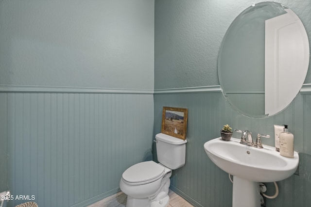3603 E Salter Dr, Phoenix, AZ 85050 - half bath featuring toilet, a wainscoted wall, and a sink