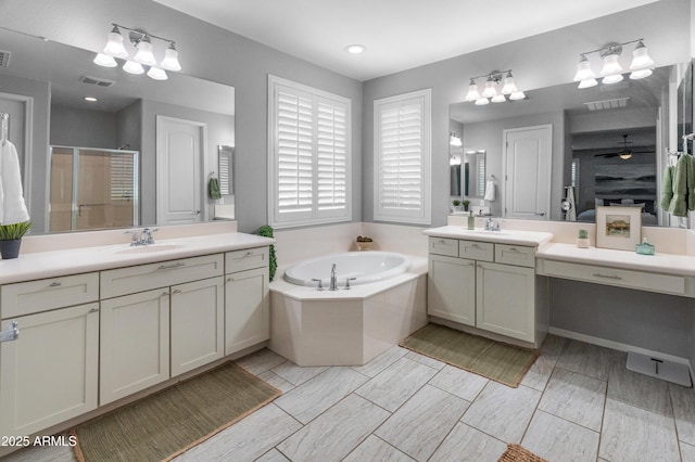 3603 E Salter Dr, Phoenix, AZ 85050 - full bathroom with visible vents, a shower stall, a garden tub, and a sink