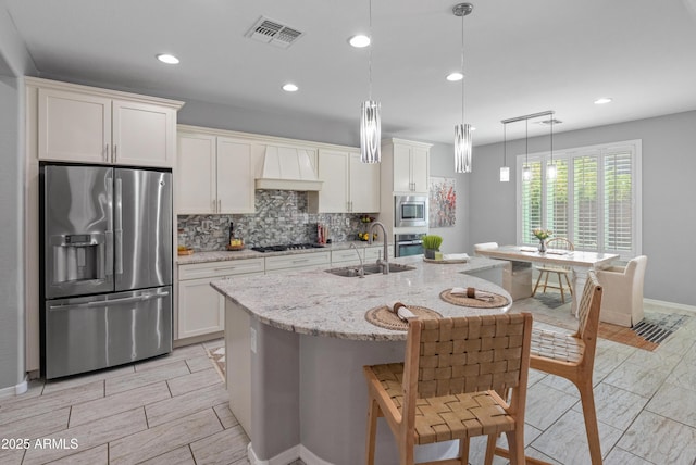 3603 E Salter Dr, Phoenix, AZ 85050 - kitchen featuring a sink, decorative backsplash, visible vents, white cabinets, and appliances with stainless steel finishes