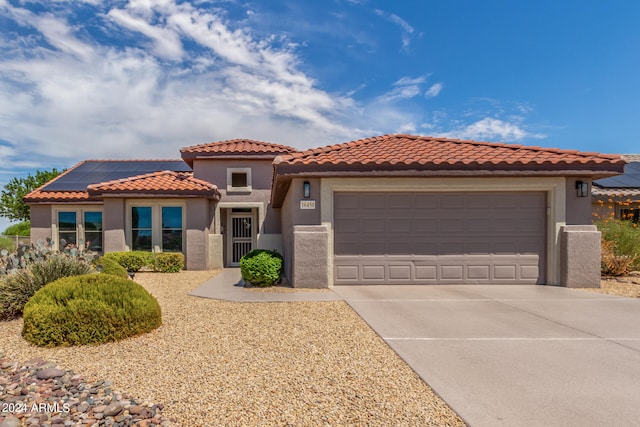 mediterranean / spanish house featuring a garage