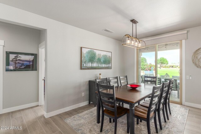 dining room featuring an inviting chandelier and light hardwood / wood-style floors