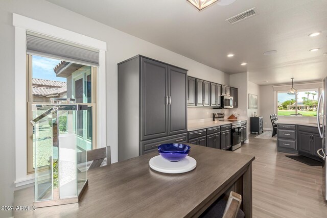 dining space featuring built in desk and light wood-type flooring