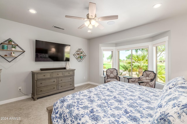 bedroom featuring multiple windows, ceiling fan, and carpet floors