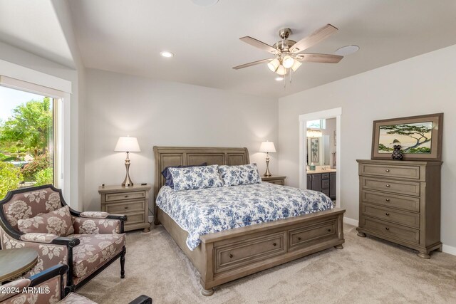 bedroom featuring light colored carpet, connected bathroom, and ceiling fan