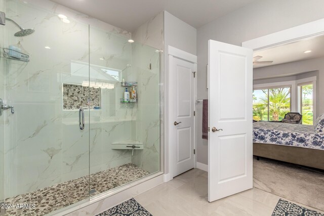 bathroom with walk in shower and ceiling fan