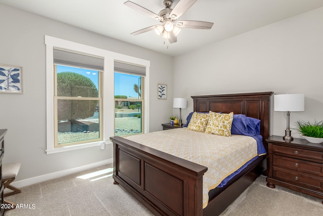 bedroom with ceiling fan and light carpet