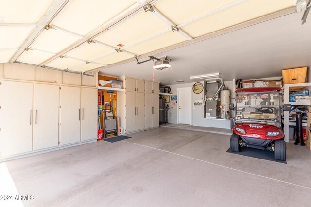 garage featuring gas water heater and a garage door opener