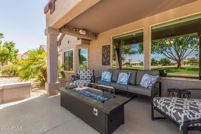 view of patio / terrace featuring an outdoor living space with a fire pit