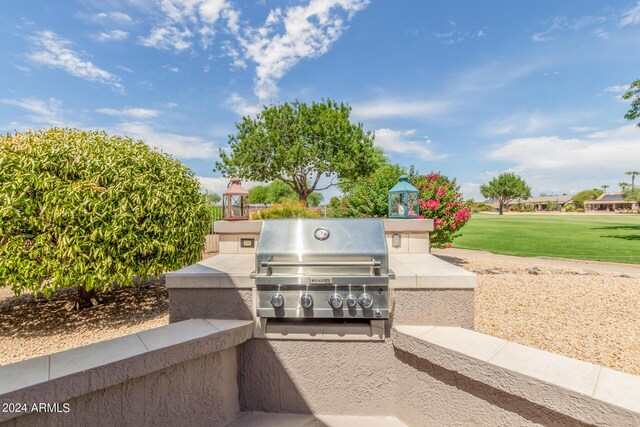 view of patio with area for grilling and a grill