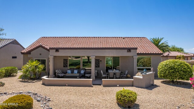 back of house with an outdoor hangout area and a patio